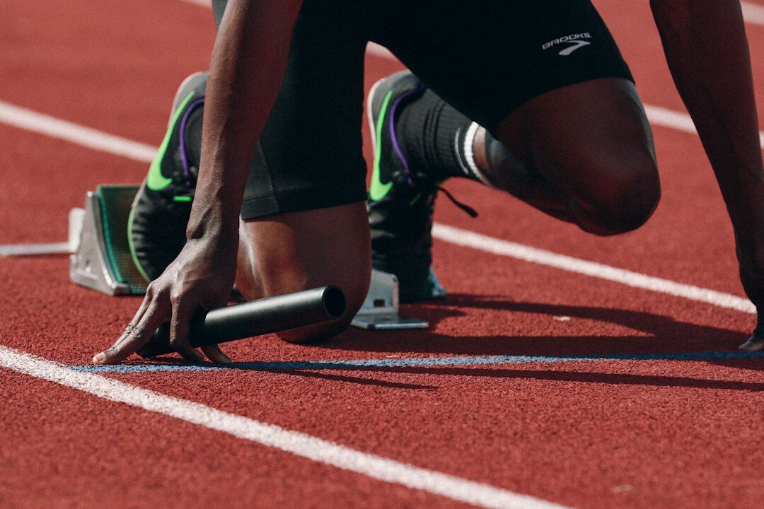 athlete running on track